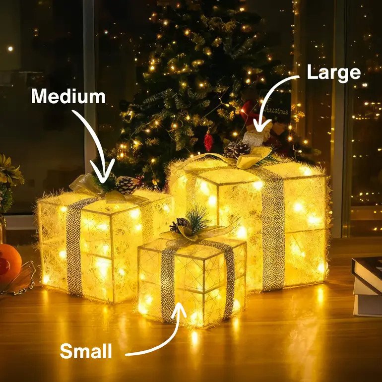 Golden Gleam Gift Box Set with three illuminated gold boxes, bows, and pinecone accents